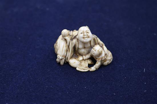 Four Japanese ivory netsuke, an okimono, an octopus and rats, a shi-shi maiju type netsuke, and two figure groups